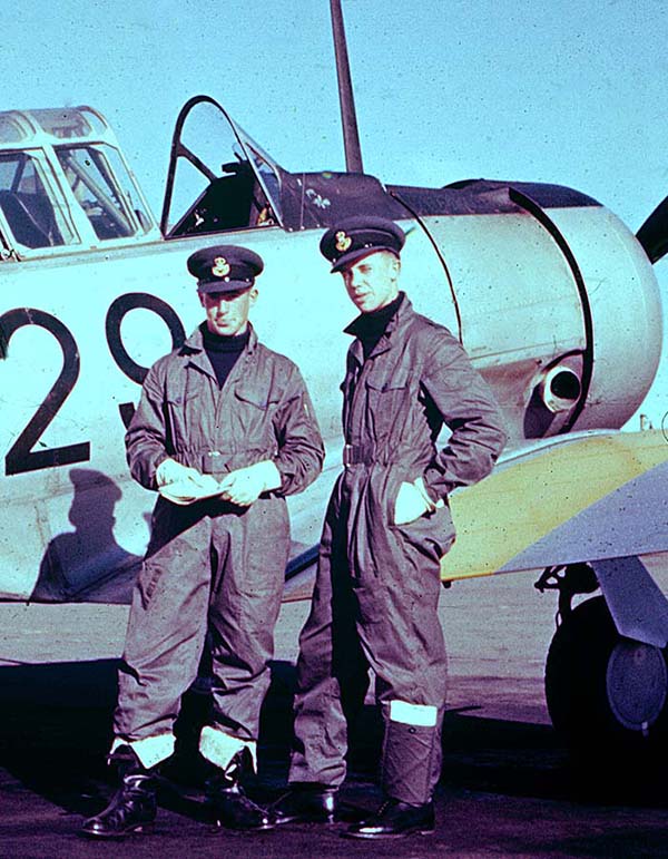 May 1957: Pete Blackgrove and me doing the war movie show-off beside our Harvard steed