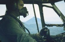 1965 Kuching: John Cotton in the pilot's seat on an airdrop mission over Sarawak