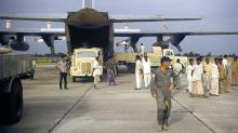 Unloading NZ7002 at Chittagong, Bangladesh in 1972.  Flight Engineer, Doug Gawne on right